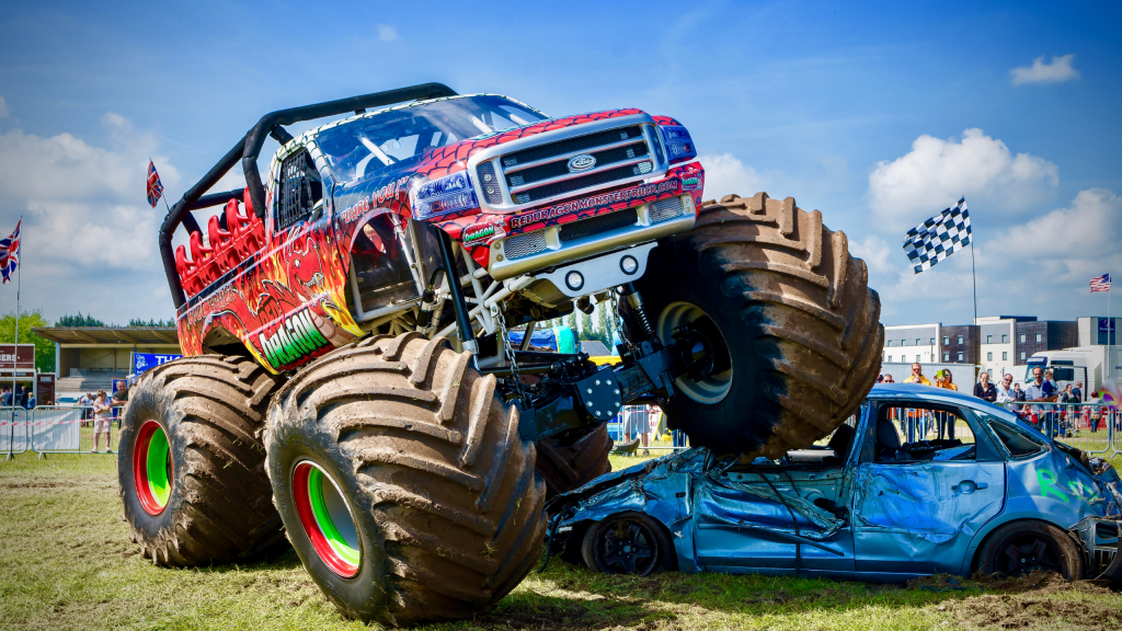 Monster truck driving over a car
